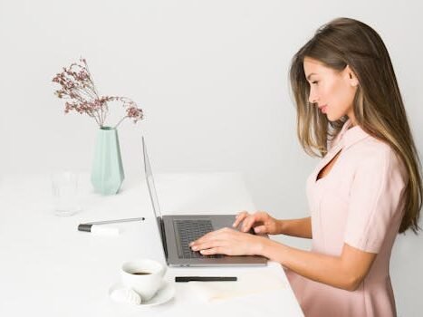 Woman in Pink Dress Using Laptop Computer